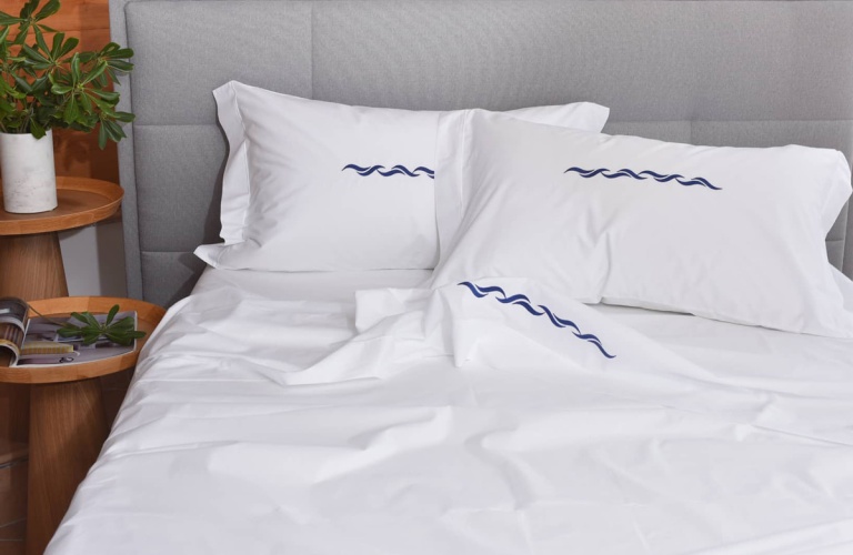 White plain colour Sheets Pelle Ovo with Wave Blue embroidery