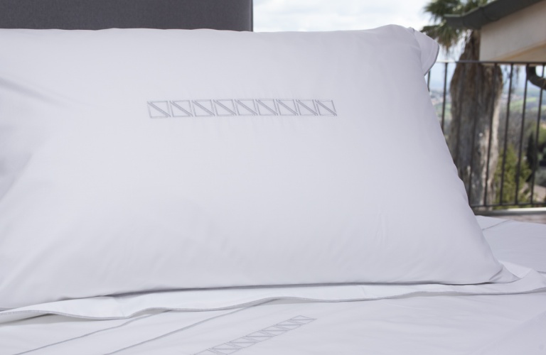 White plain colour Sheets Pelle Ovo with Bauhaus embroidery
